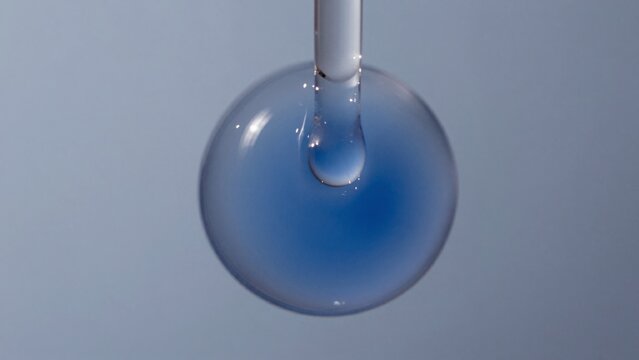 High-resolution featuring close-up transparent spherical object suspended thin white cylindrical appears made