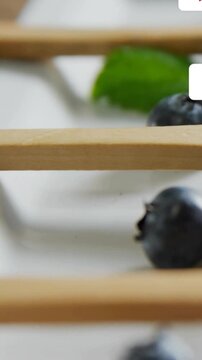 Vertical video: Badges entering right cascading over blueberry, counts changing showing engagement