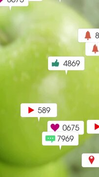 Vertical video: Bubbles popping and drifting across wet green apple macro after social buzz for ads