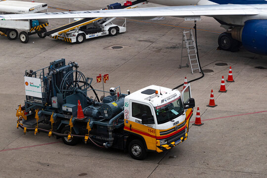 GUARULHOS - BRAZIL - April 02 2024 - Tanker truck Volkswagen e-Delivery 11, operated by Shell, refueling a Boeing 737 with jet A fuel at Guarulhos International Airport.
