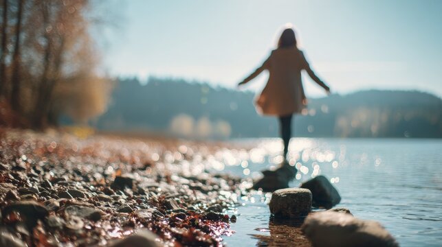 woman skipping stones lake with blured nature background