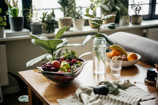 Big tray with different fresh fruits and vegetables on the table. Healthy organic food and eating at home concept.