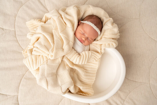 Sleeping newborn wrapped in soft blanket