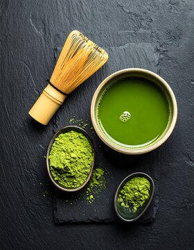 Matcha tea bowl, whisk, & powder, shot overhead on dark stone
