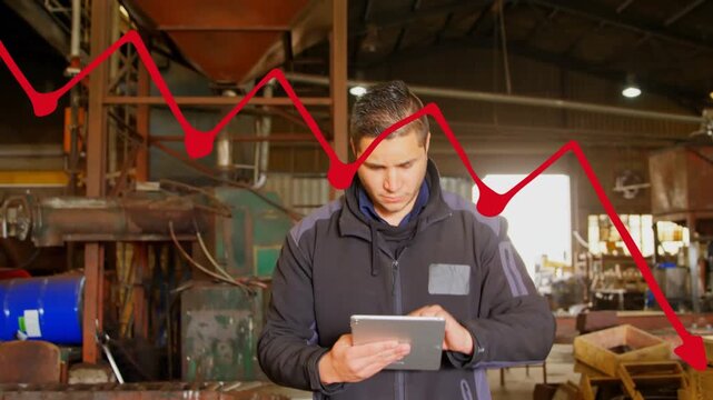 Animation of red digital line graph downgrading over caucasian worker using digital pc in factory