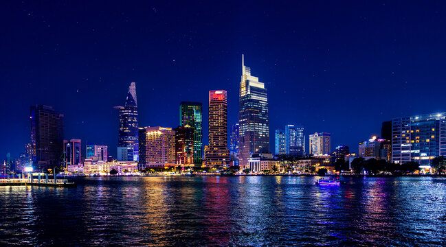 Coastline with skyscrapers of Ho chi minh or Saigon city in Vietnam, night panorama