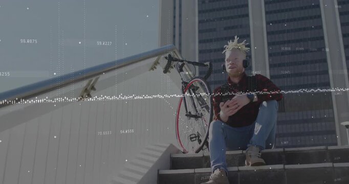 Man using smartphone on urban stairs, with waveform and data visualization overlays for technology