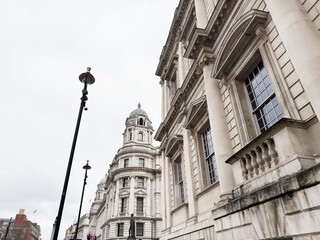 Fototapeta premium Neoclassical Old War Office Building government building facade and street lamps in central London, UK cityscape