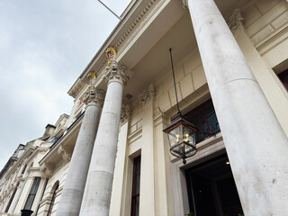 Fototapeta premium Neoclassical building facade with grand columns and hanging lantern in London UK