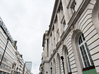 Fototapeta premium Neoclassical building with grand columns on a London, UK street under an overcast sky
