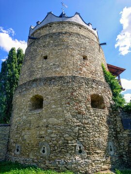 Medieval defensive stone tower of Letychiv Castle with arrow slits and stone masonry