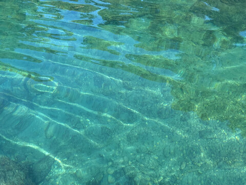 Sea clear water with underwater pebbles 