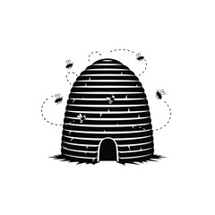Fototapeta premium Bees fly around a traditional beehive with entrance at the bottom outdoors in nature.