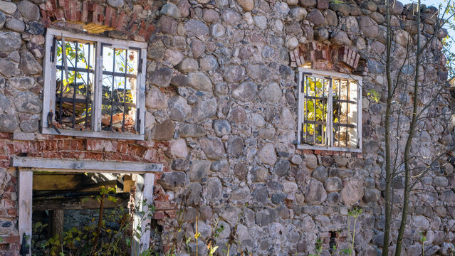 Ruins of an old stone building with arched windows in Latvia