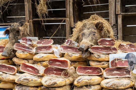 Pork ham stand at the village market - France