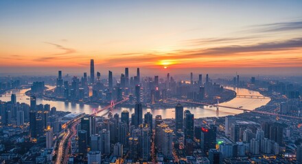 Fototapeta premium City skyline at sunset with buildings and river in vibrant orange sky
