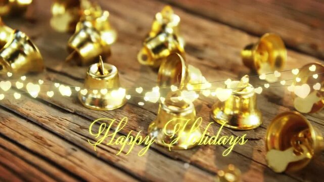 Animation of text, happy holidays, in yellow, over string lights and christmas bell decorations