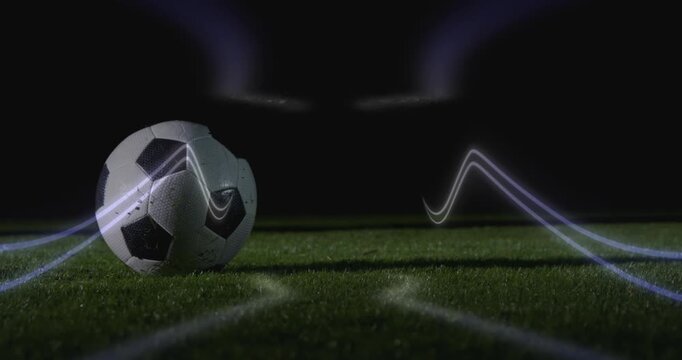 Animation of neon shapes over football player kicking ball at stadium