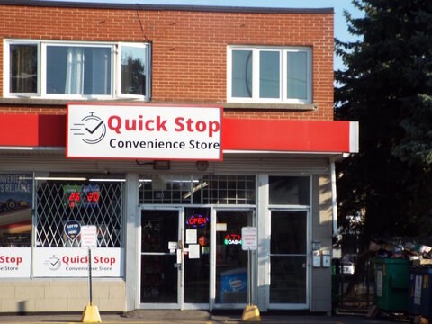 Vanier, Ontario, Canada &ndash; July 25, 2025: "Quick Stop Convenience Store" features a red and white storefront sign and window advertisements at 431 Donald Street.
