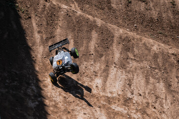 Radio-controlled car jumping on dirt track © Zoran Jesic