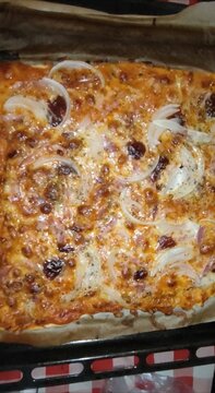 Delicious homemade rectangular pizza baking in oven