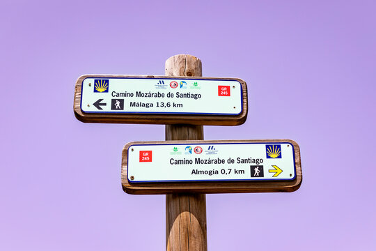 GR 245 Camino Mozarabe de Santiago - way of Saint James way marker showing direction and distances to Almogia and Malaga, Andalusia, Spain