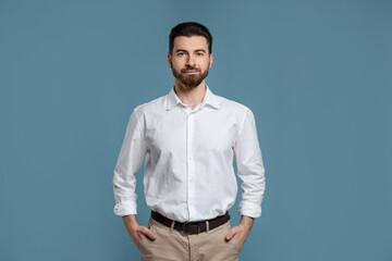 Obraz premium Portrait of handsome man on light blue background