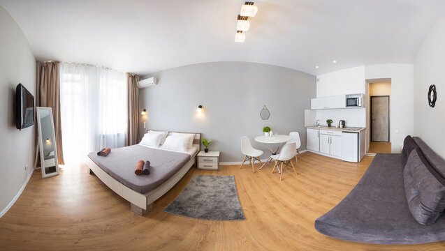 Panoramic shot of a miniature apartment with a bedroom and a kitchen.