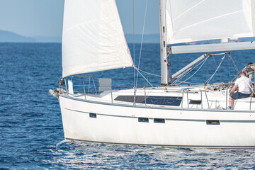 Fototapeta premium Sailboat cruising on open blue sea water