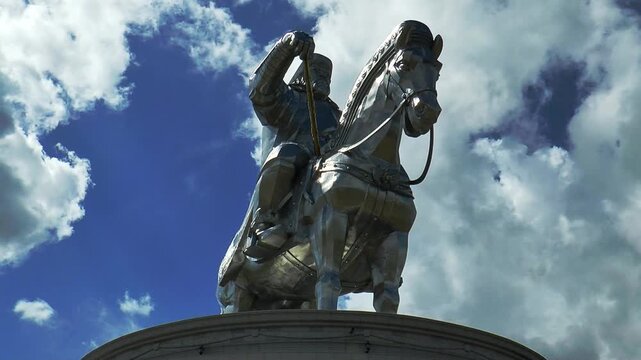 Ulaanbaatar, Mongolia - July 31, 2015: Huge majestic monument to Chinggis Khan in Mongolia on 
background of blue sky and flying clouds. Time lapse.