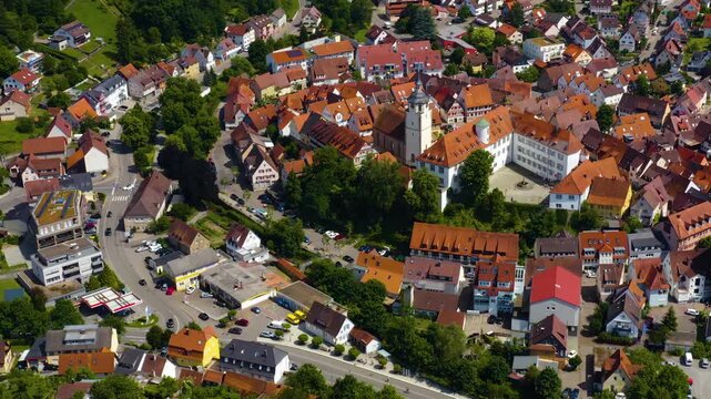 An panoramic aerial view around the old town in the city Waldenbuch on a sunny summer noon in Germany .