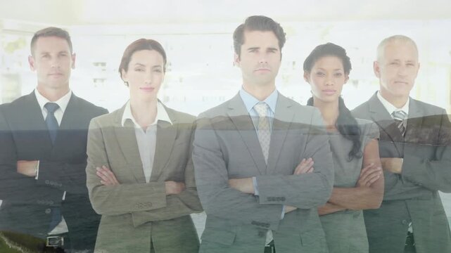 Composite video of diverse businesspeople with arms crossed against aerial view of sea waves