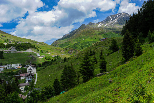 Charming alpine village with church and snow-capped peak in Andermatt

