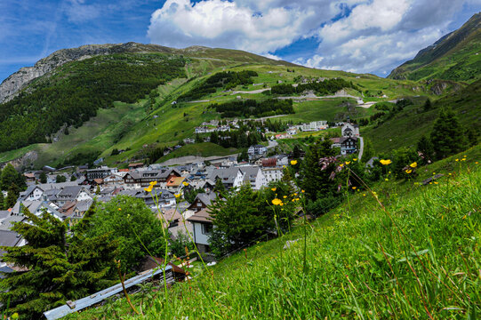 Charming alpine village with church and snow-capped peak in Andermatt
