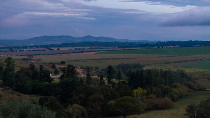 Naklejka premium Dramatic African Landscape with Colorful Sky and Rural Fields