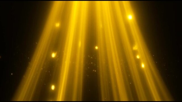 Golden light beams shine brightly in darkness with yellow rays and particles.