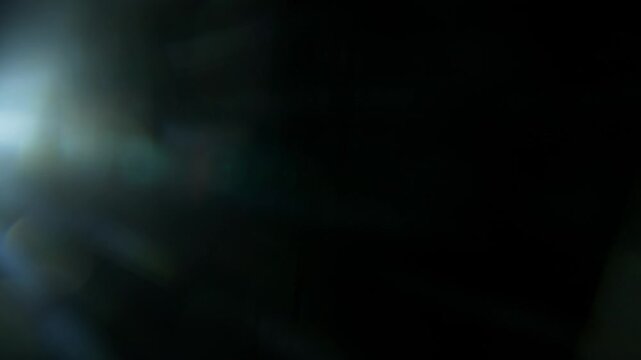 Real Cinematic Lens Flare Overlay on Black Background at 1000fps Slow Motion.