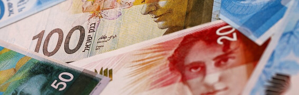 Israel shekel money bills pile on table. Israel banknotes of ILS currency close up.