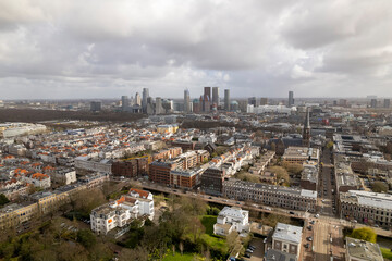 Obraz premium Sunlight illuminating aerial view of Den Haag, The Netherlands, with skyline cityscape of The Hague and residential ambassadors neighbourhood in the foreground. Dutch peace and political capital city 