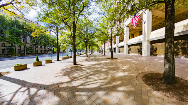Hoover Building in Washington DC with American flags and open plaza view