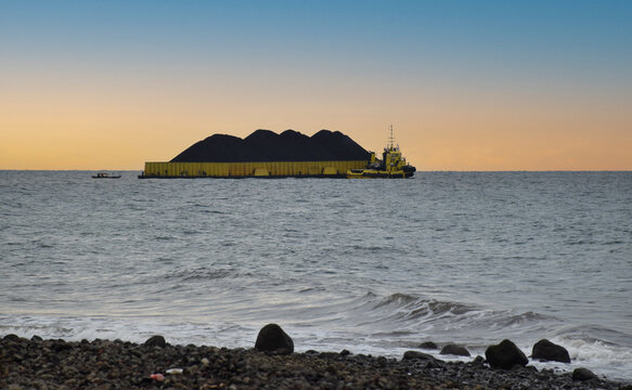 A coal-fired power plant barge supplying coal for combustion in Paiton, Probolinggo, Indonesia