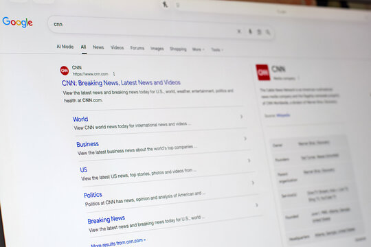 Computer monitor showing CNN website listed on Google search results page. Online browsing scene highlighting news access, search engine use, and digital media consumption