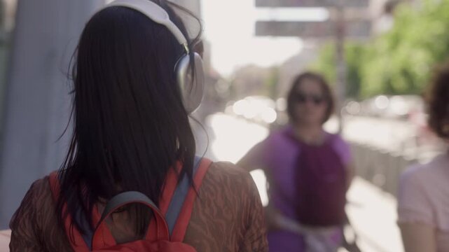 Happy young woman dancing while listening to music outdoors