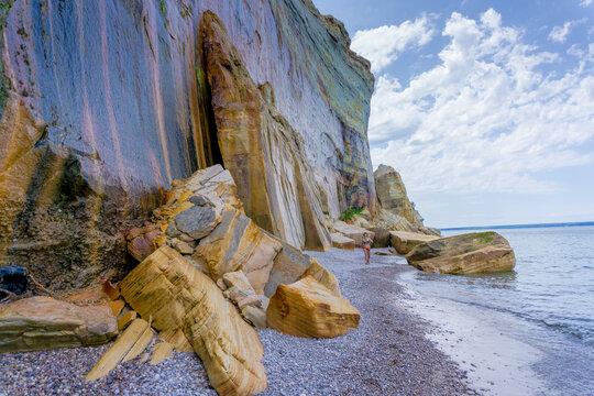 Towering cliffs meet gentle waves at this coastal beach