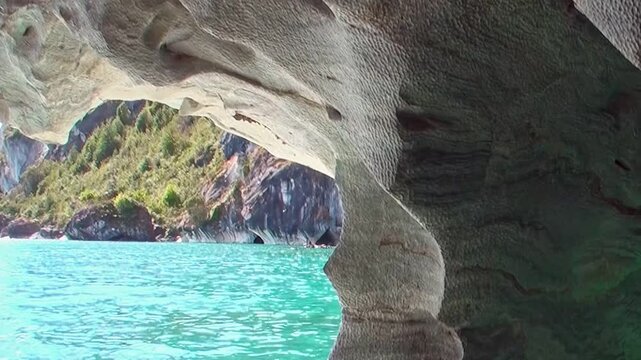 Witness the ethereal beauty of Patagonia's Marble Caves on General Carrera Lake. Turquoise waters dance with sculpted marble formations under brilliant sunlight, inviting serene exploration.