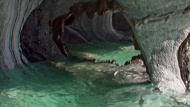Witness the majestic Marble Caves of Patagonia. Emerald waters gently caress unique, sculpted rock formations within General Carrera Lake, revealing nature's serene artistry.