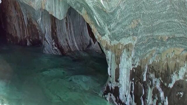 Witness the breathtaking beauty of the Marble Caves in Patagonia. Azure waters gently lap against swirling, sculpted marble walls, revealing natures artistic handiwork.