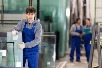 During work process, guy employee produces blanks for repairs and interior decoration. He carries...