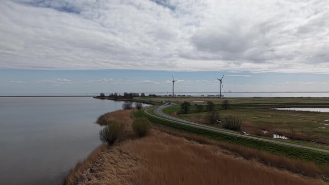 Scenic Coastal Road and Wind Turbines Near Marken, Netherlands - aerial drone video, April 2026