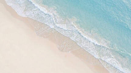 Top-down aerial view of pristine tropical beach with white sand and clear turquoise ocean waves gently breaking. © kashurin